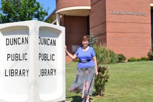 Library director Jan Cole stands in front of Duncan Public Library