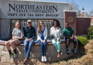 NSU students in front of entry sign