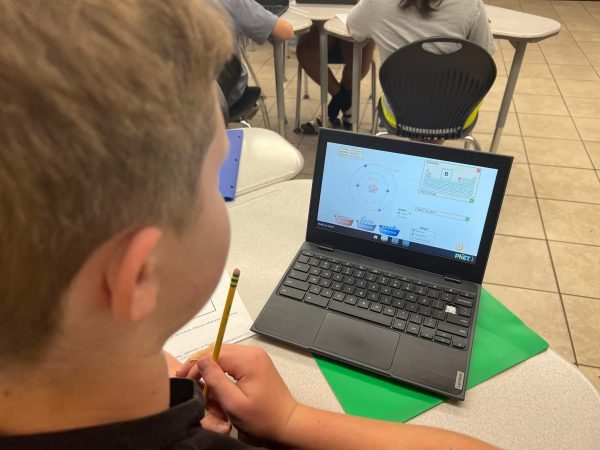 Young, male student working on a laptop