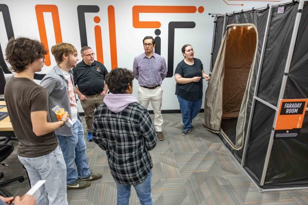 Group of students gathered around a faraday room