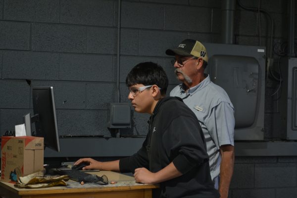 student and instructor working on a computer