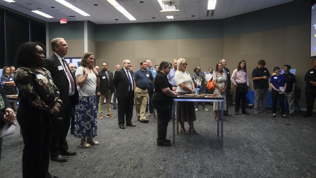 Various subscribers in reception room listening to speaker