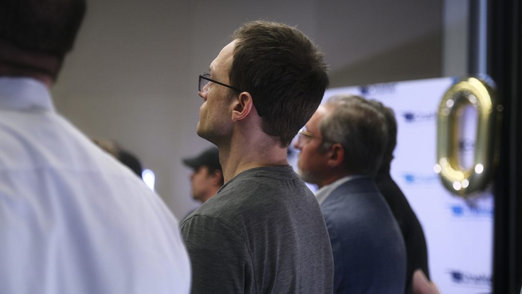 Rear view of staff and subscribers watching anniversary video