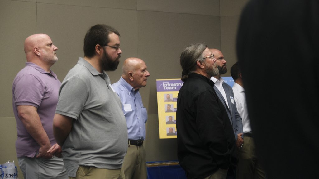 Reception guests watching anniversary video